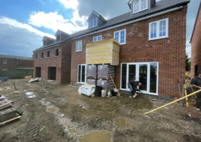 Floor screed contractor at work outside a new build in Desborough