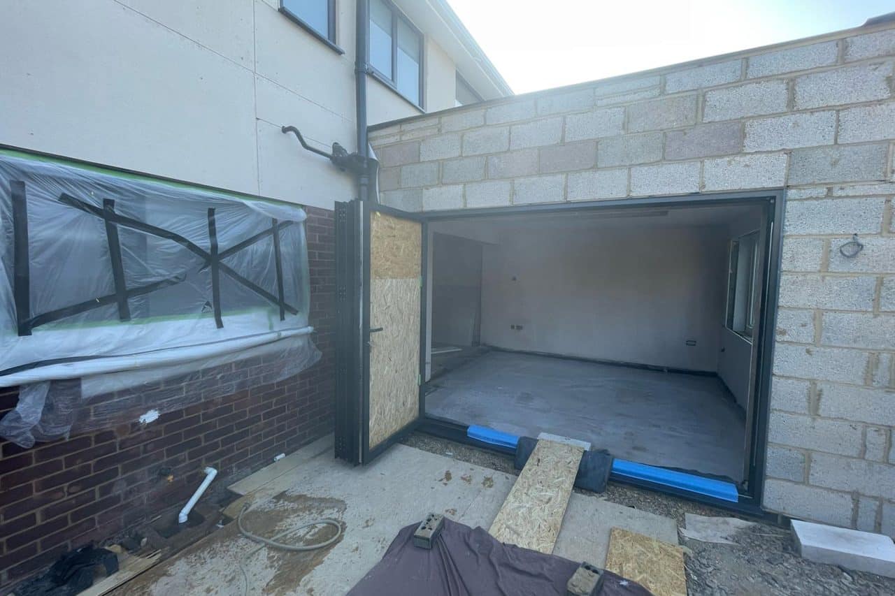Primed, concrete floor at a home extension in Milton Keynes