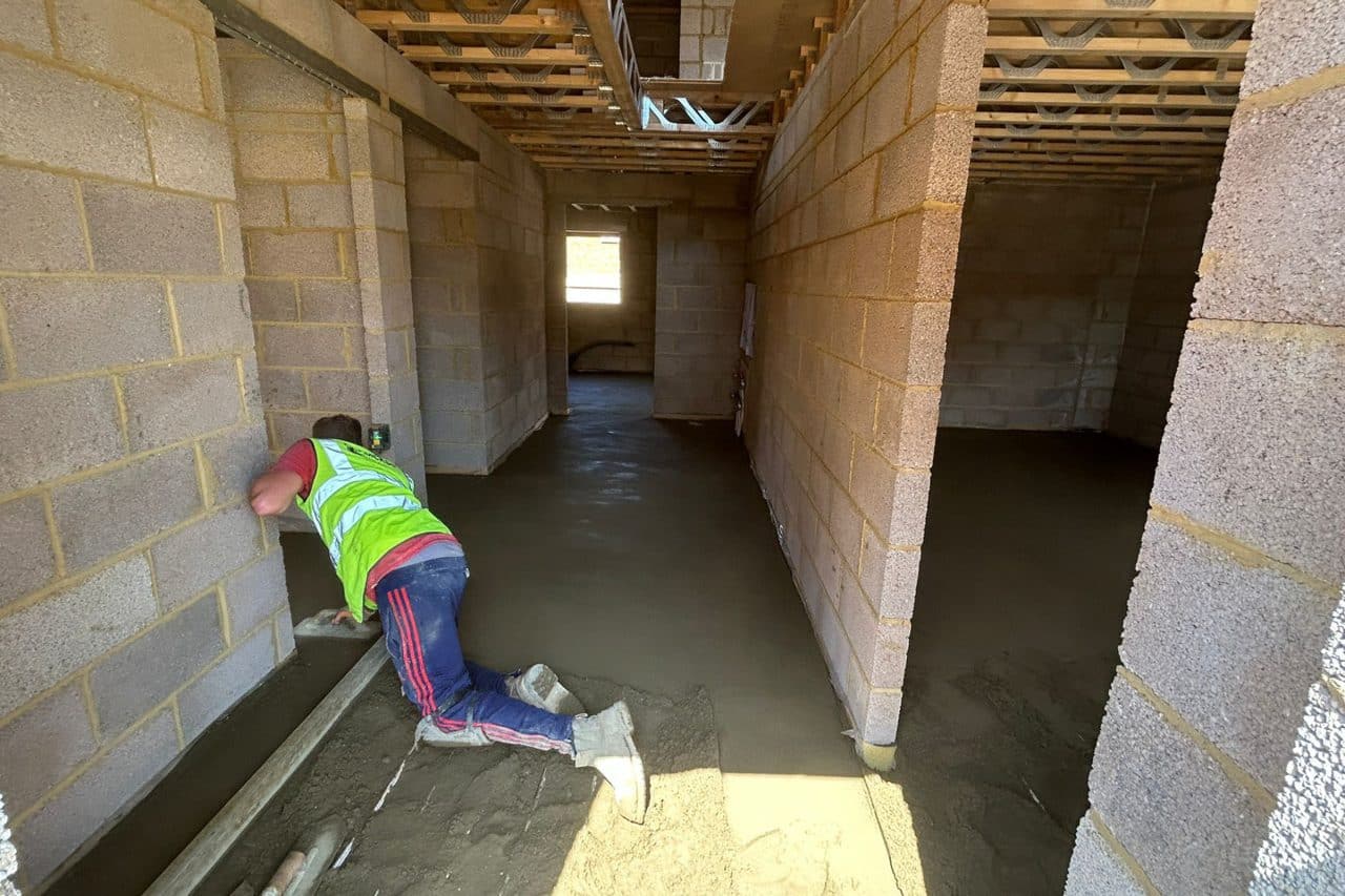 Floor screeder working at a new build in Hardingstone, Northampton