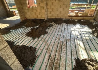 Floor screed installation over underfloor heating at a new building at Braybrooke, Northamptonshire