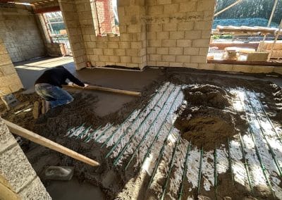 Floor screed contractor working at a new building at Braybrooke, Northamptonshire