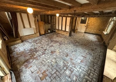 Screed spiders set out in a period property - Steel liquid screed levelling tripod used to set the depth of the screed