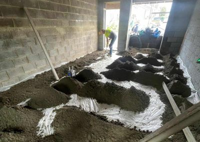 Workers installing floor screed