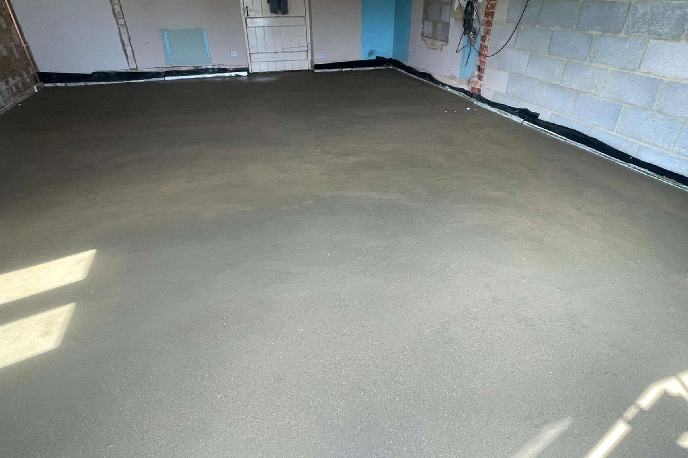 Floor screed at a home extension in Kettering Newly installed floor screed surface in home extension project