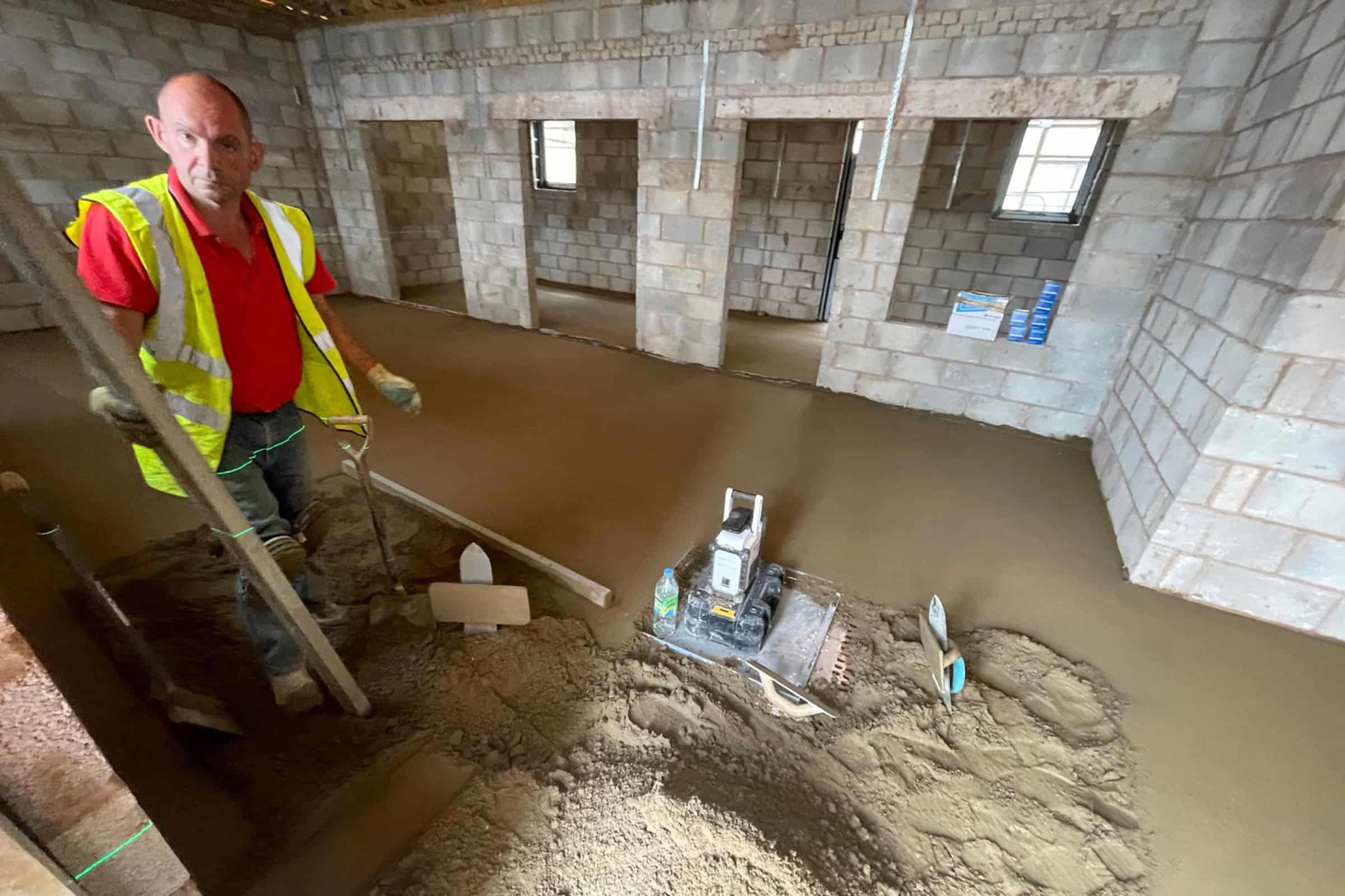 Contractor and newly installed floor screed surface at a hospital