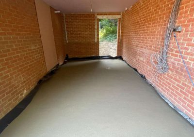 Completed floor screed project at a garage in a new build property