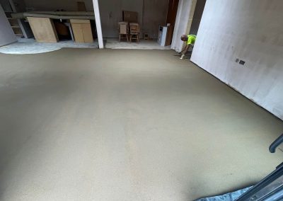 Newly installed floor screed surface in home extension project