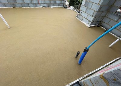 Newly installed floor screed surface in home extension project