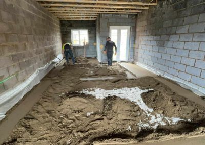 Workers installing floor screed