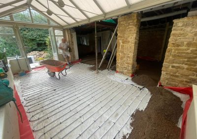 Underfloor heating pipes laid out at a new build property with partially completed floor screed