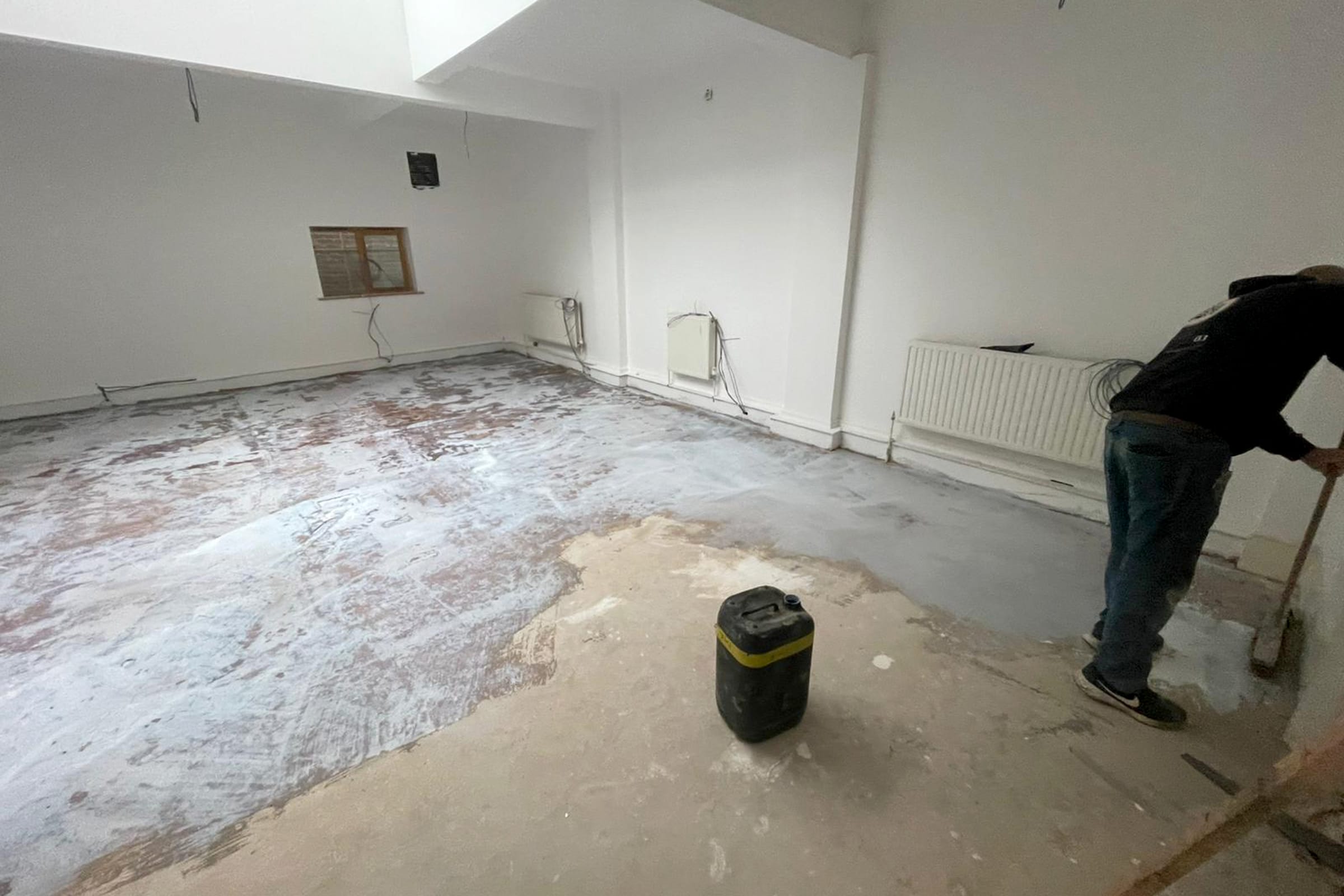 Worker installing latex screed