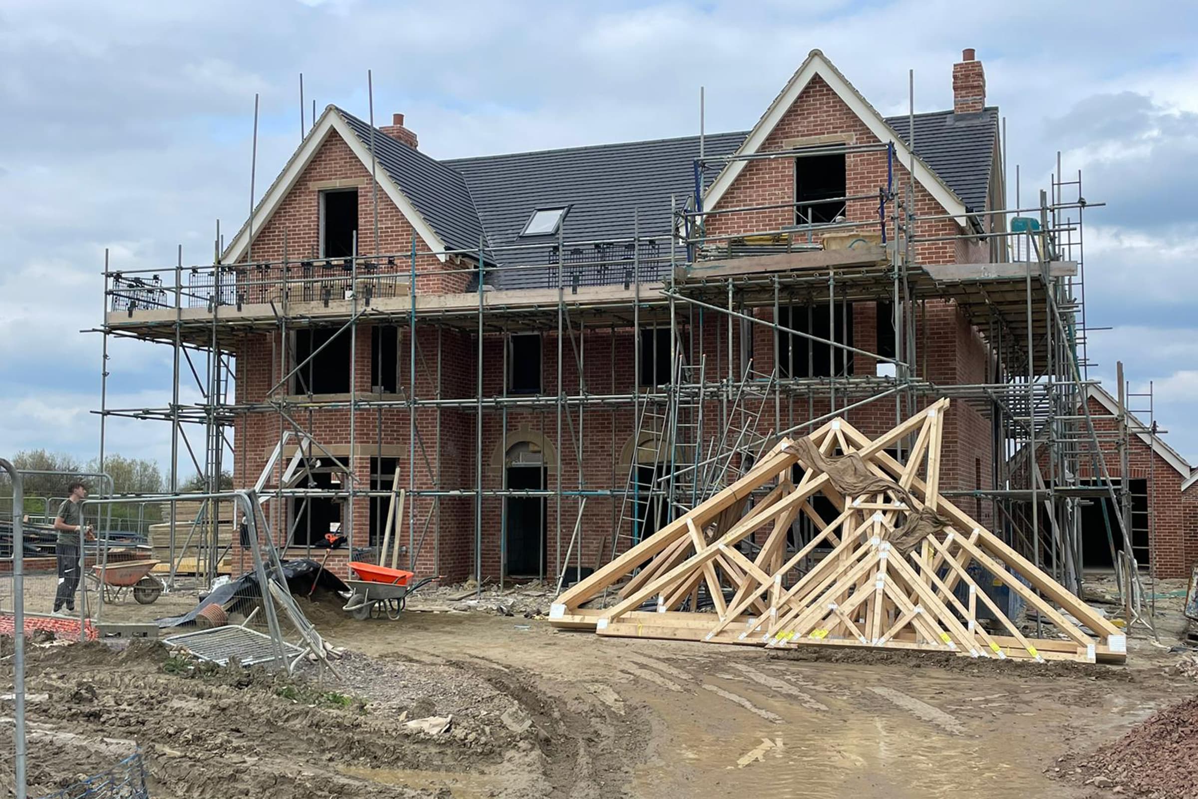 Exterior of a new build property with scaffold and building materials