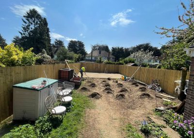 Contractor using a straight edge to accurately apply floor screed material and create a perfectly level floor surface for a patio area