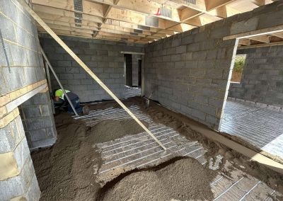 Underfloor heating pipes laid out at a new build property with partially completed floor screed