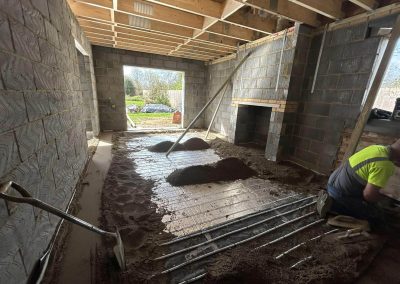 Underfloor heating pipes laid out at a new build property with partially completed floor screed