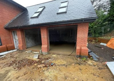 Newly installed floor screed surface in an open fronted double garage