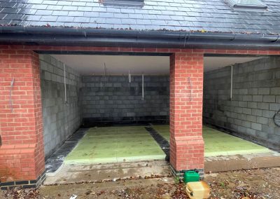 Newly installed insulation in an open fronted double garage