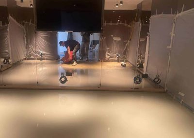 Worker applying self-levelling screed floor