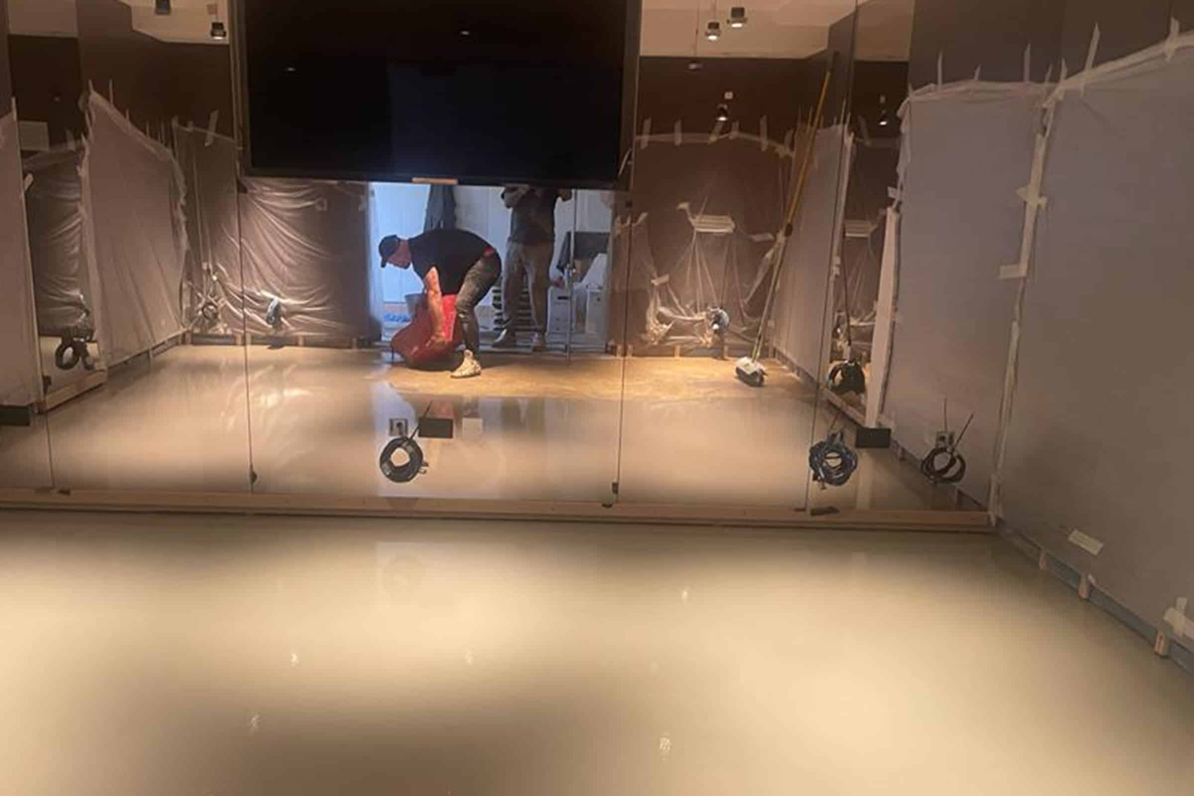 Worker applying self-levelling screed floor