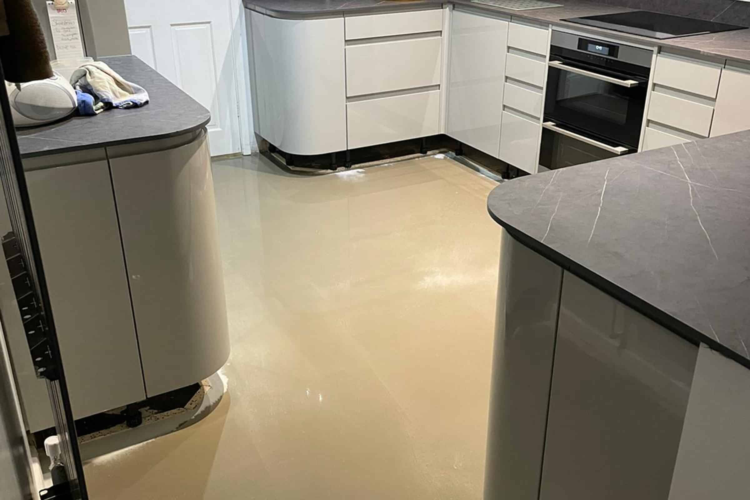 Newly installed latex floor screed surface in a kitchen