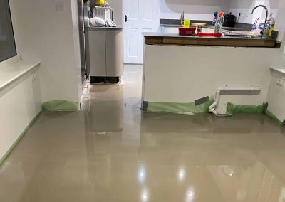 Newly installed latex floor screed surface in a kitchen