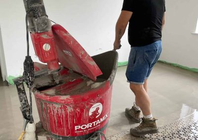 Worker using cement mixer