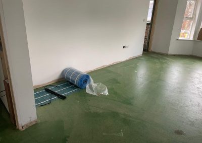 Electric underfloor heating mesh being unrolled