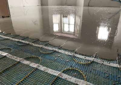Electric underfloor heating mesh partially covered by self levelling compound