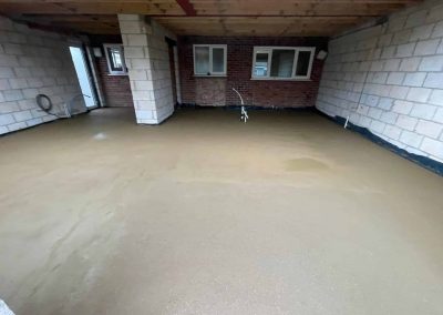 Newly installed floor screed surface at a home extension project
