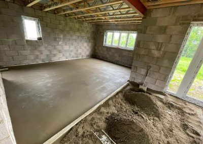 Underfloor heating pipes laid out at a new build with partially completed floor screed