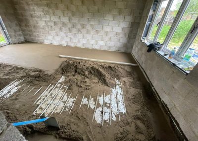 Underfloor heating pipes laid out at a new build with partially completed floor screed