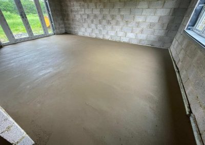 Newly installed floor screed surface at a home extension project