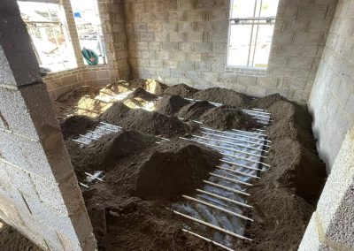Underfloor heating pipes laid out at a new build project with partially completed floor screed