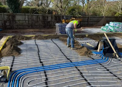 Man working on a floor screed project at a new build building site plot