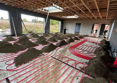 Underfloor heating pipes laid out at a new build property with partially completed floor screed