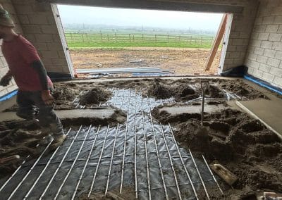Worker installing underfloor heating screed